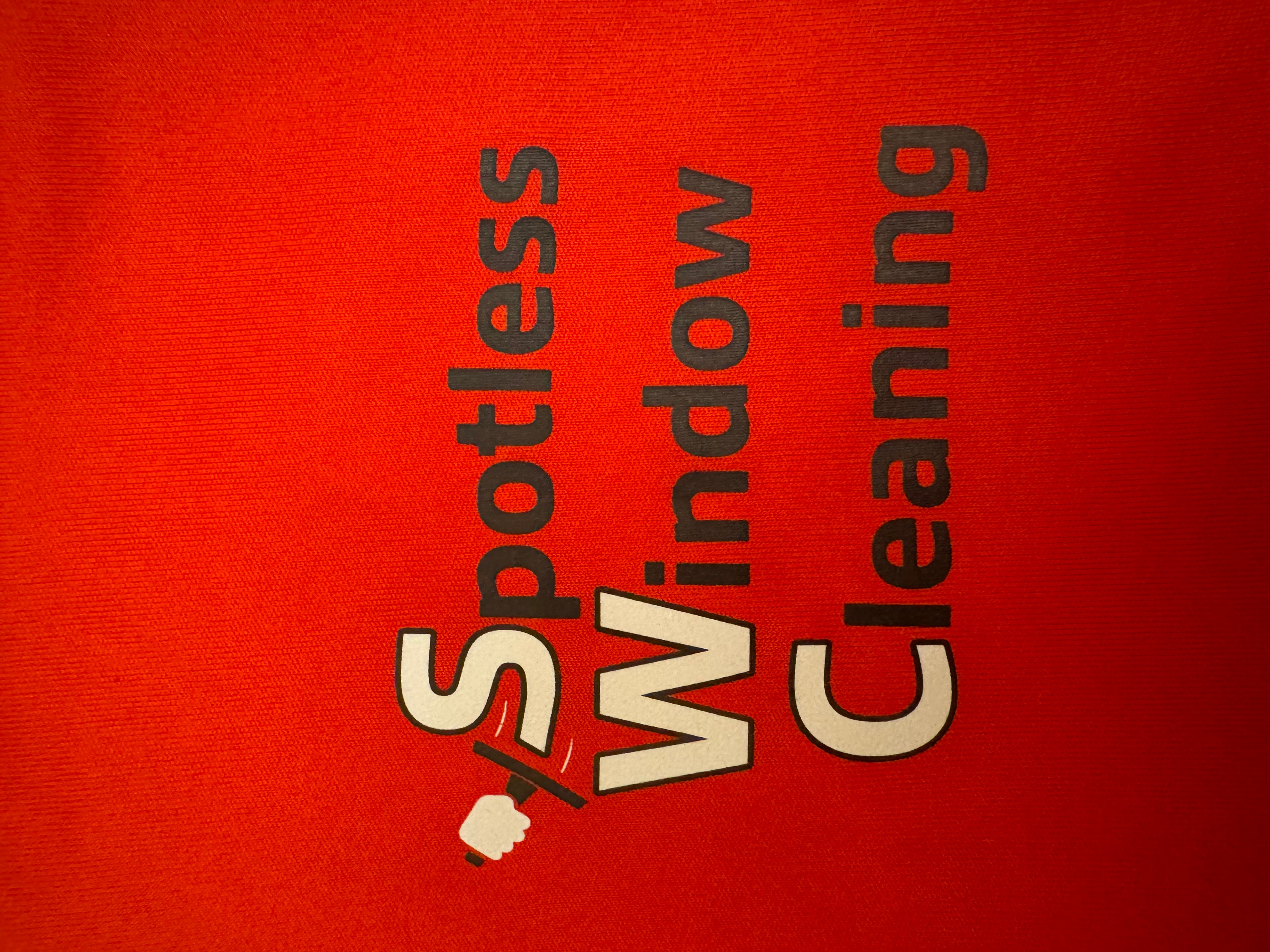 Red background with black and white text reading 'Spotless Window Cleaning' and a squeegee icon.